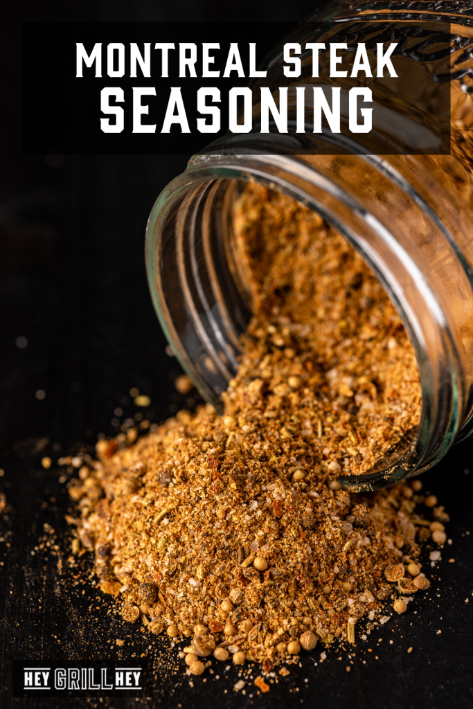 Montreal steak seasoning pouring out of a glass bottle with text overlay - Montreal Steak Seasoning.