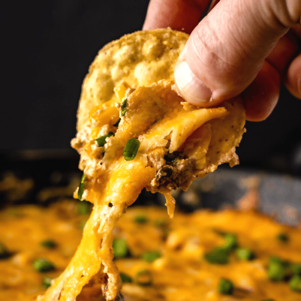Corn chip dipped in hot corn dip.