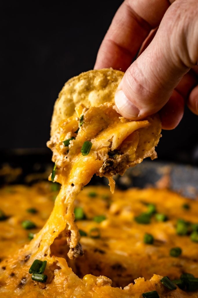 Corn chip dipped in hot corn dip.