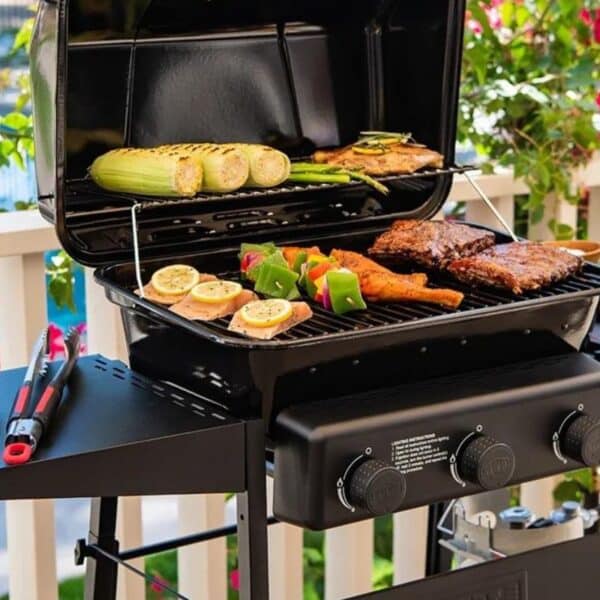 A grill loaded with meat and veggies on a patio.